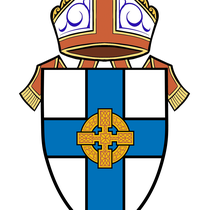 A crest with a shield-like design with a blue cross over it, gold cross in centre, topped with a white, mitre with red and gold edging